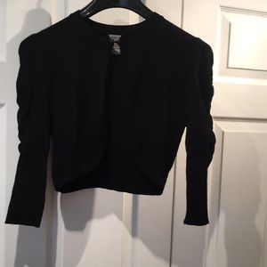 Black bolero-style sweater with puff sleeves
